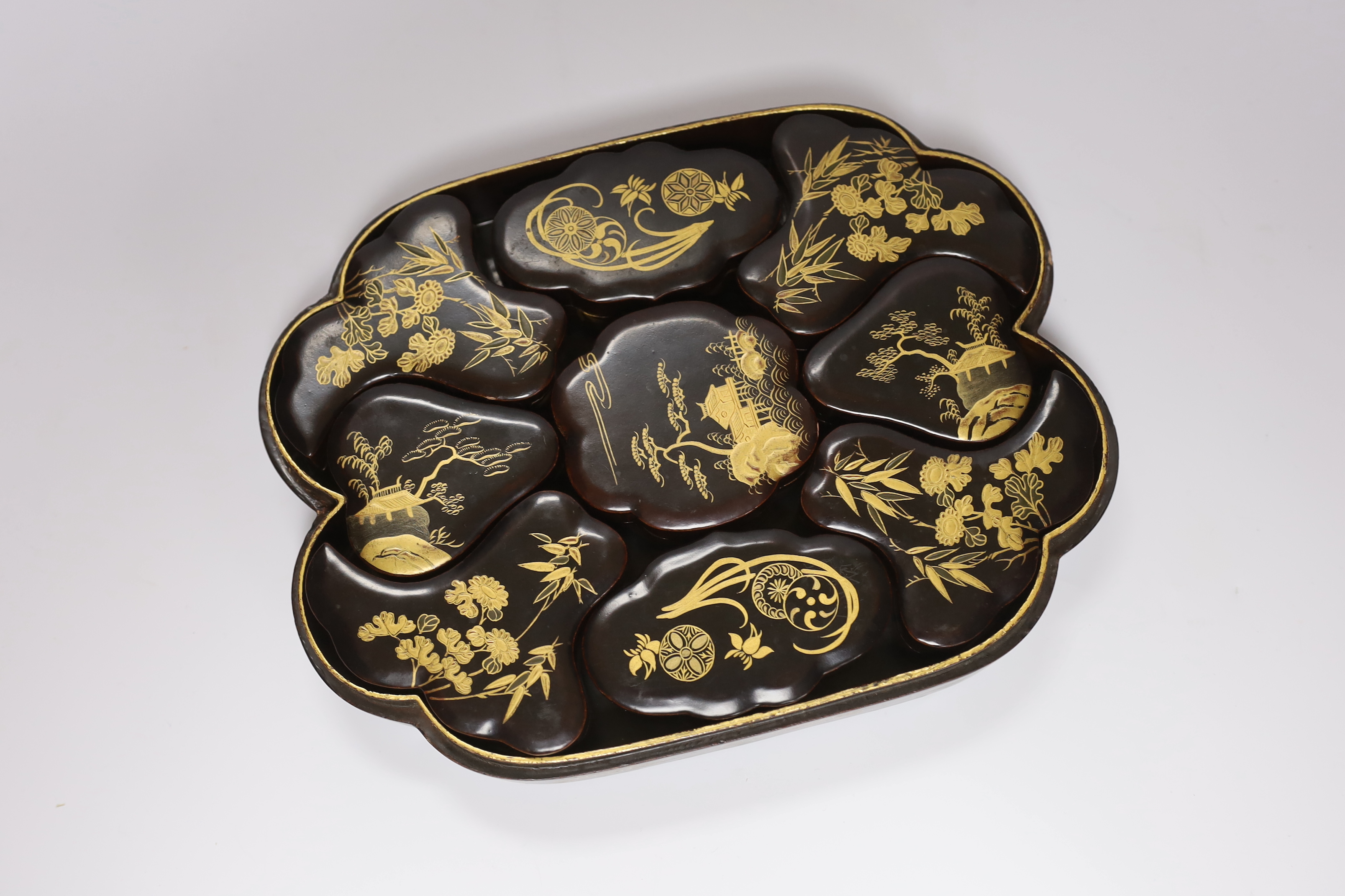 An early 20th century Japanese gilt lacquer box containing nine similar boxes, 28cm